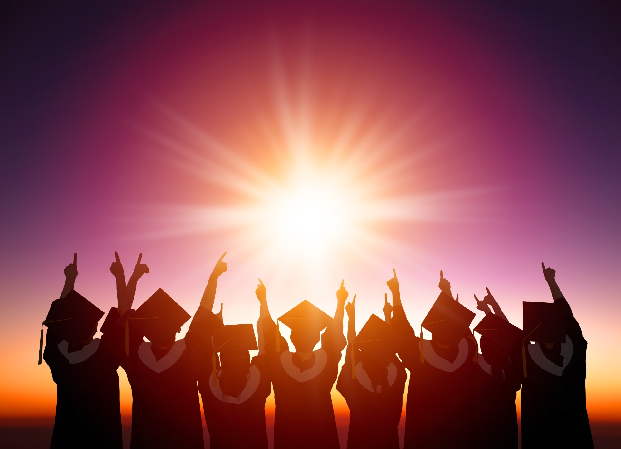 silhouette of Students Celebrating Graduation watching the sunli